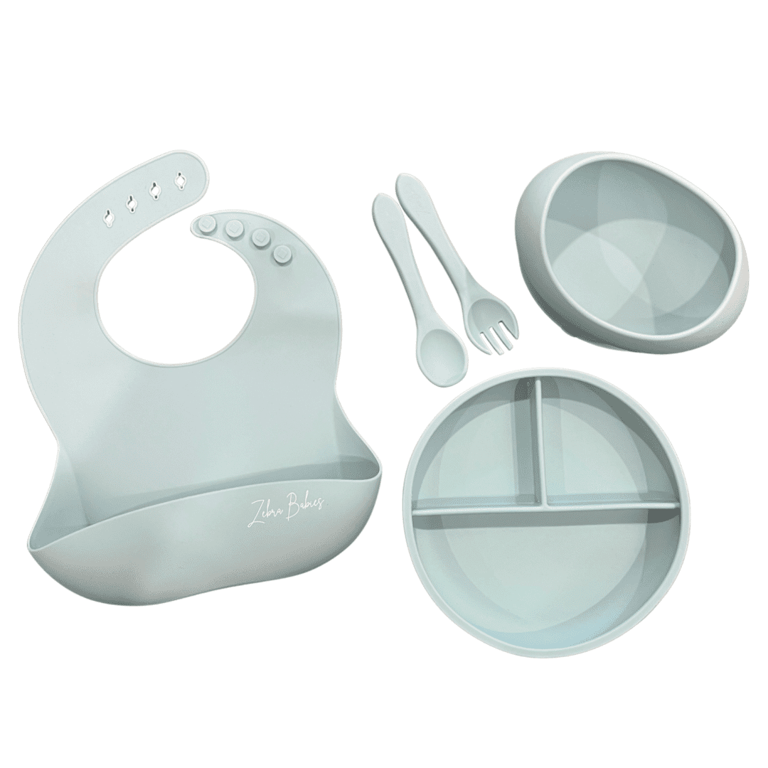 silicone Feeding set - Silicone suction bowl, silicone suction plate, fork, spoon cutlery set and silicone scoop bib – 5pc Baby Tableware Set SAVE with this value silicone baby feeding set. Our large oval silicone suction bowl, matching suction plate with standard cutlery set and silicone bib.  Large oval design to help encourage self feeding. The curved design allows the matching spoon to be levelled, less mess! Paired with one of our silicone bibs for easy clean up! Strong silicone suction with an easy release tab, keeping food off the floor and in baby’s belly.